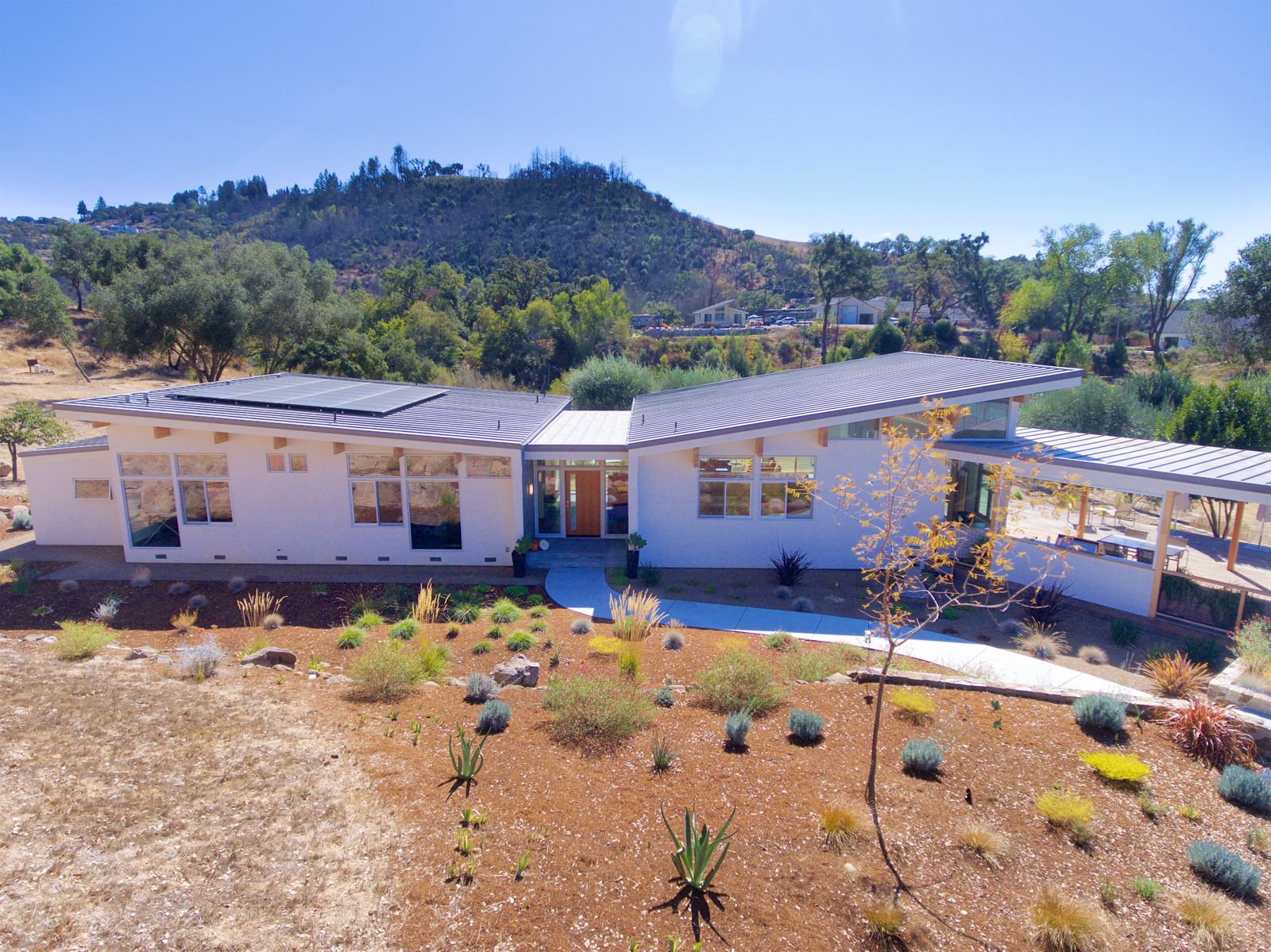 Aerial — front elevation against the hillside