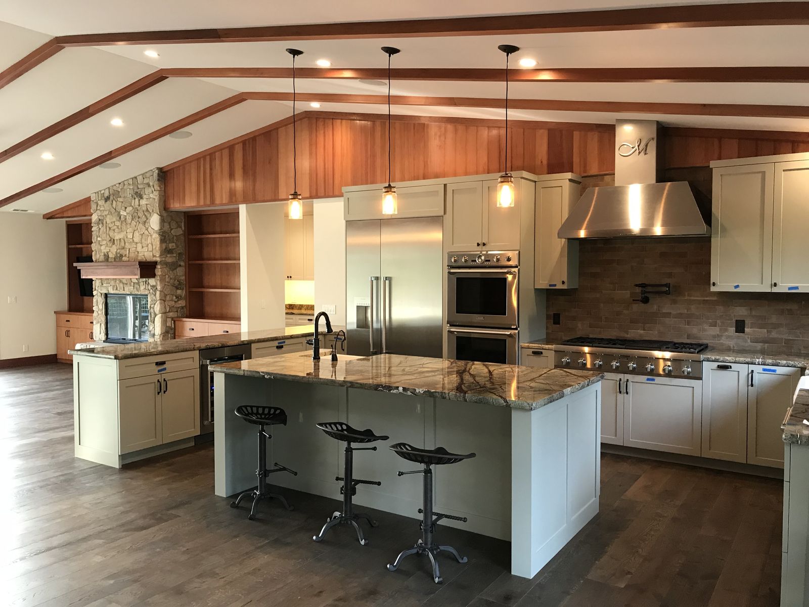 Kitchen with vaulted ceiling and waterfall island.