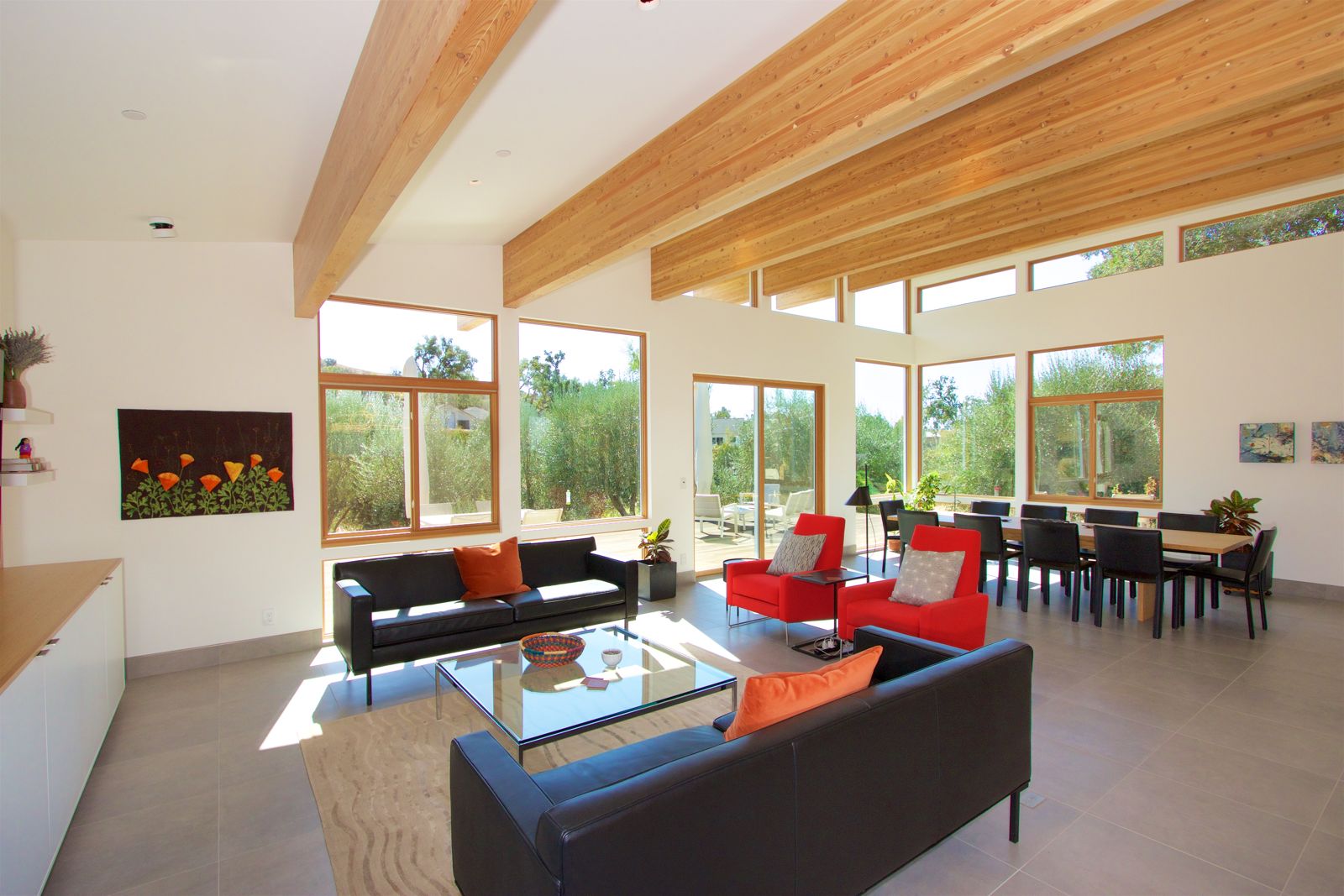 Great room — exposed beams and a wall of windows