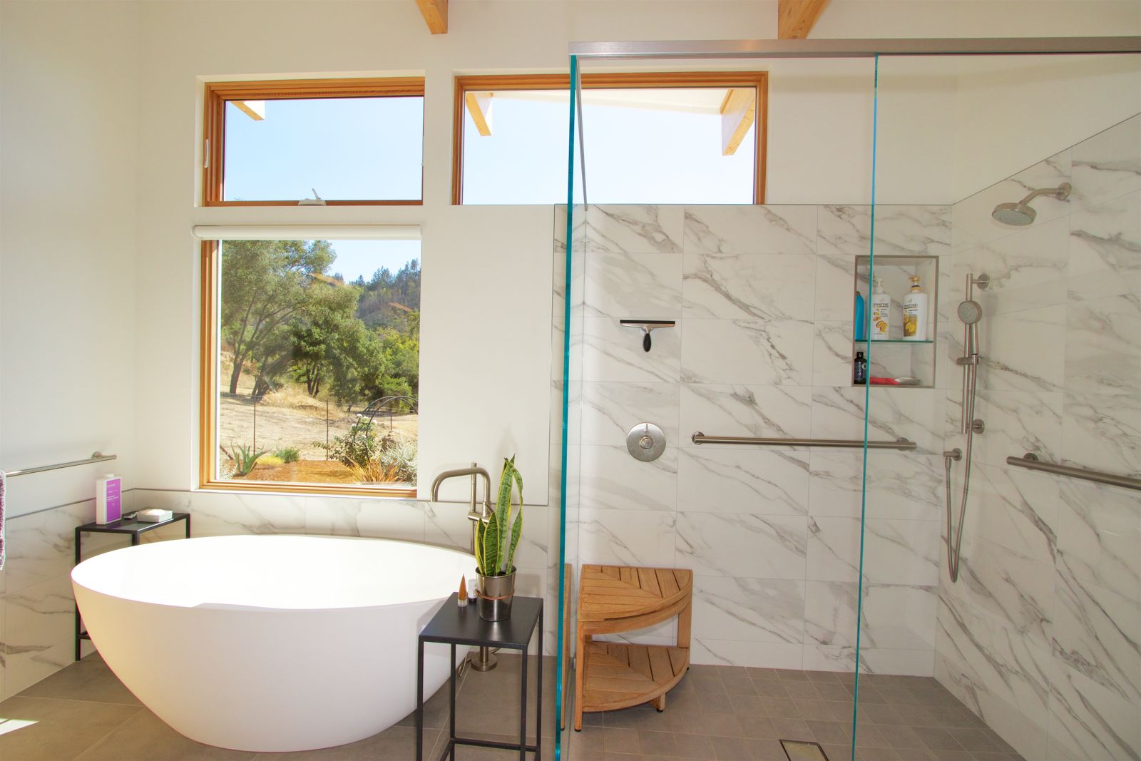 Primary bath — marble-tiled shower with window views