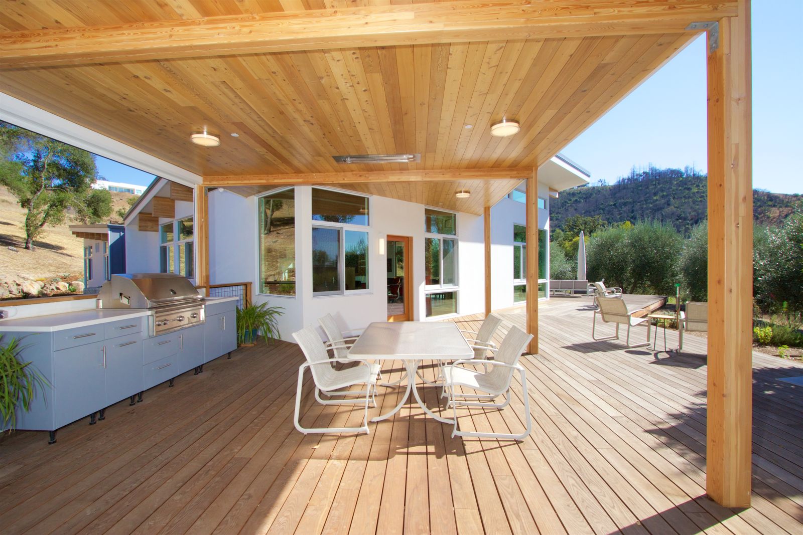 Outdoor kitchen and dining deck with built-in grill