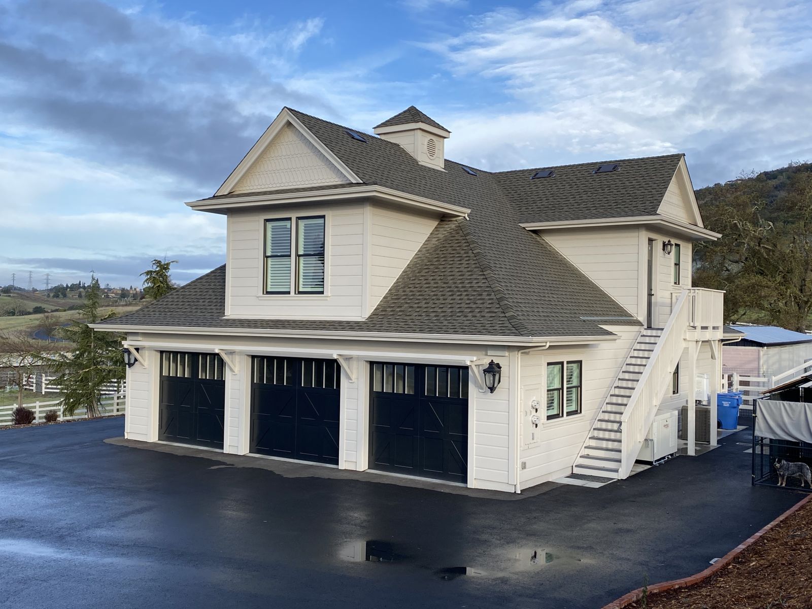 Custom carriage house — three-bay garage with loft above