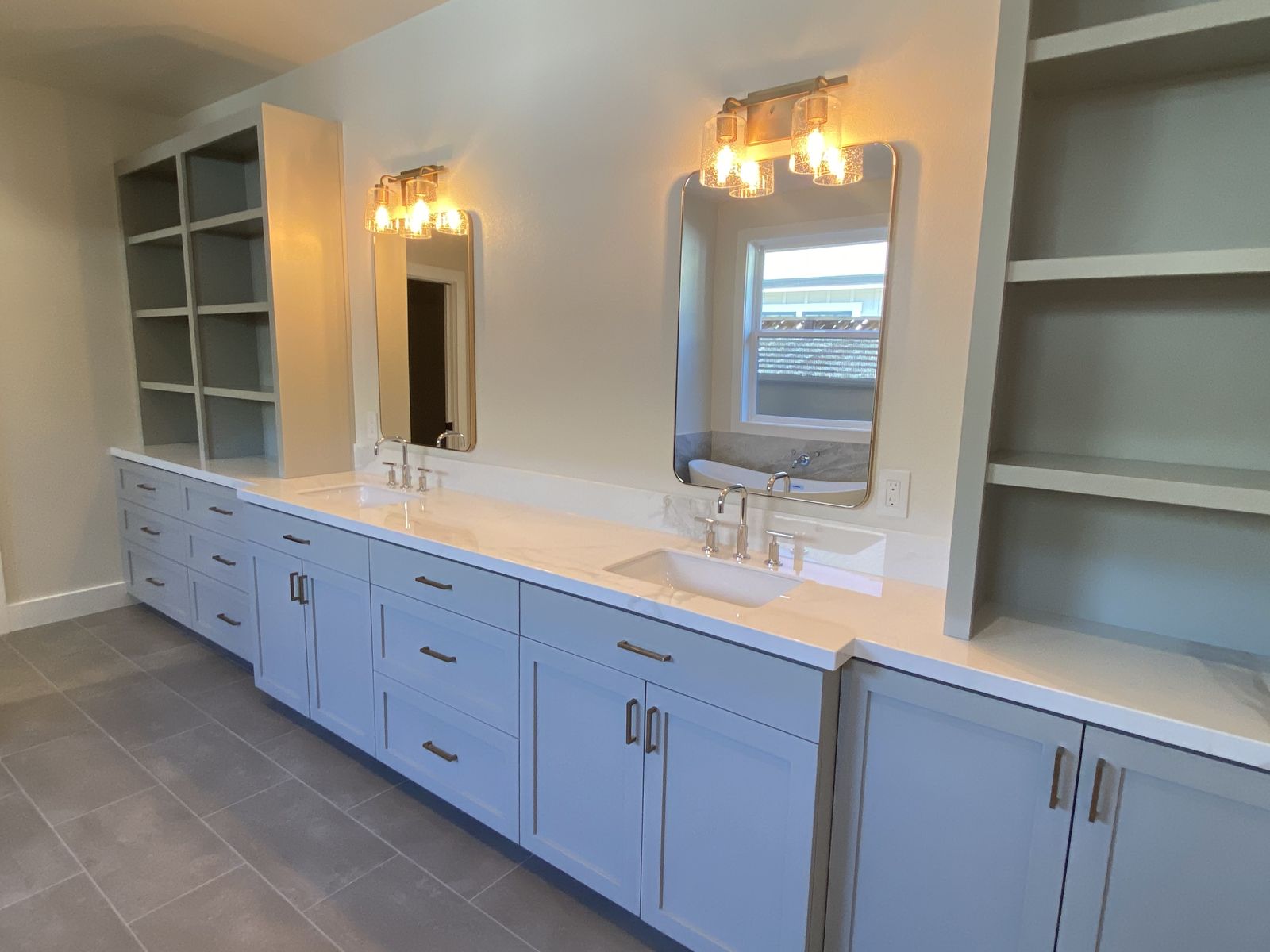 Double vanity — custom painted cabinetry and sconces