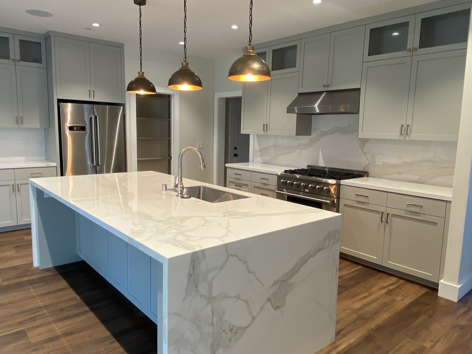 Kitchen remodel — custom hood and glass-front uppers