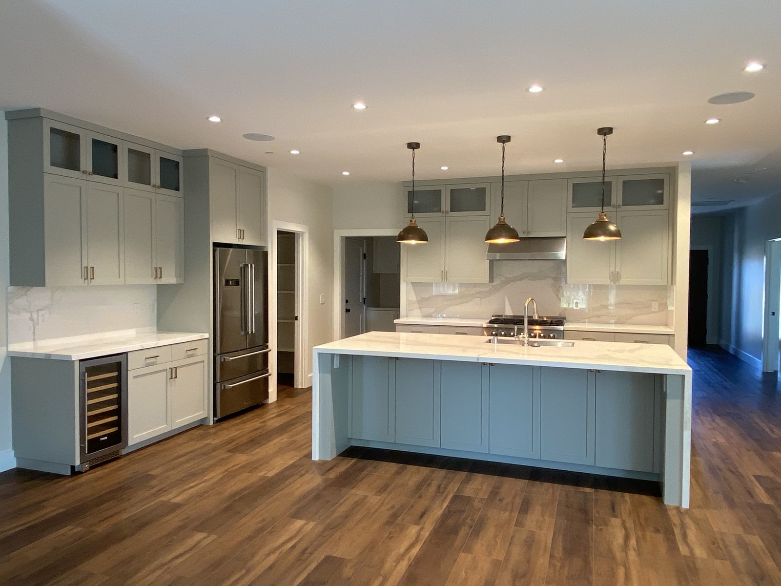 Kitchen remodel with beverage center and pantry wall.